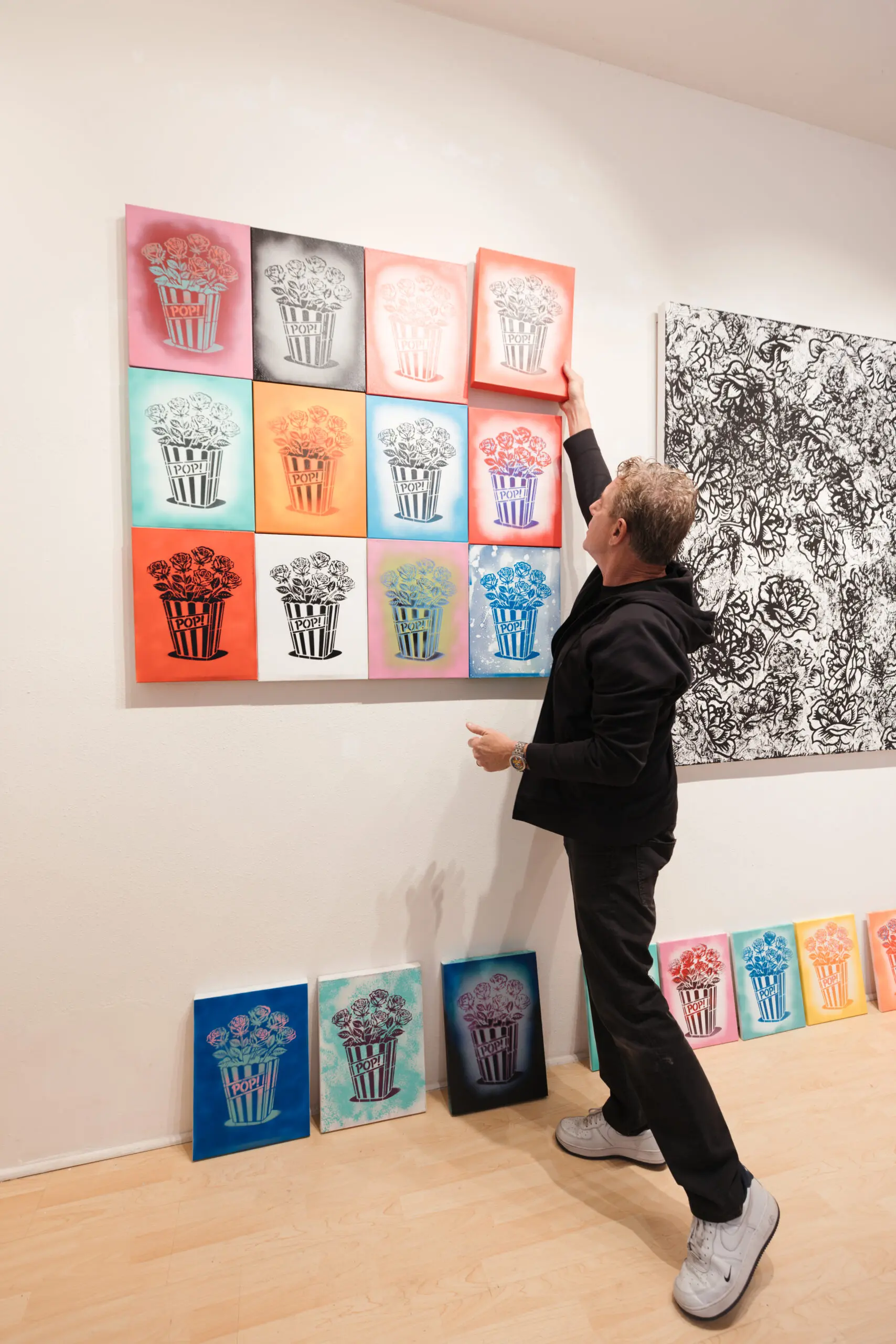 Burton Morris hanging a popcorn work at MASH Gallery