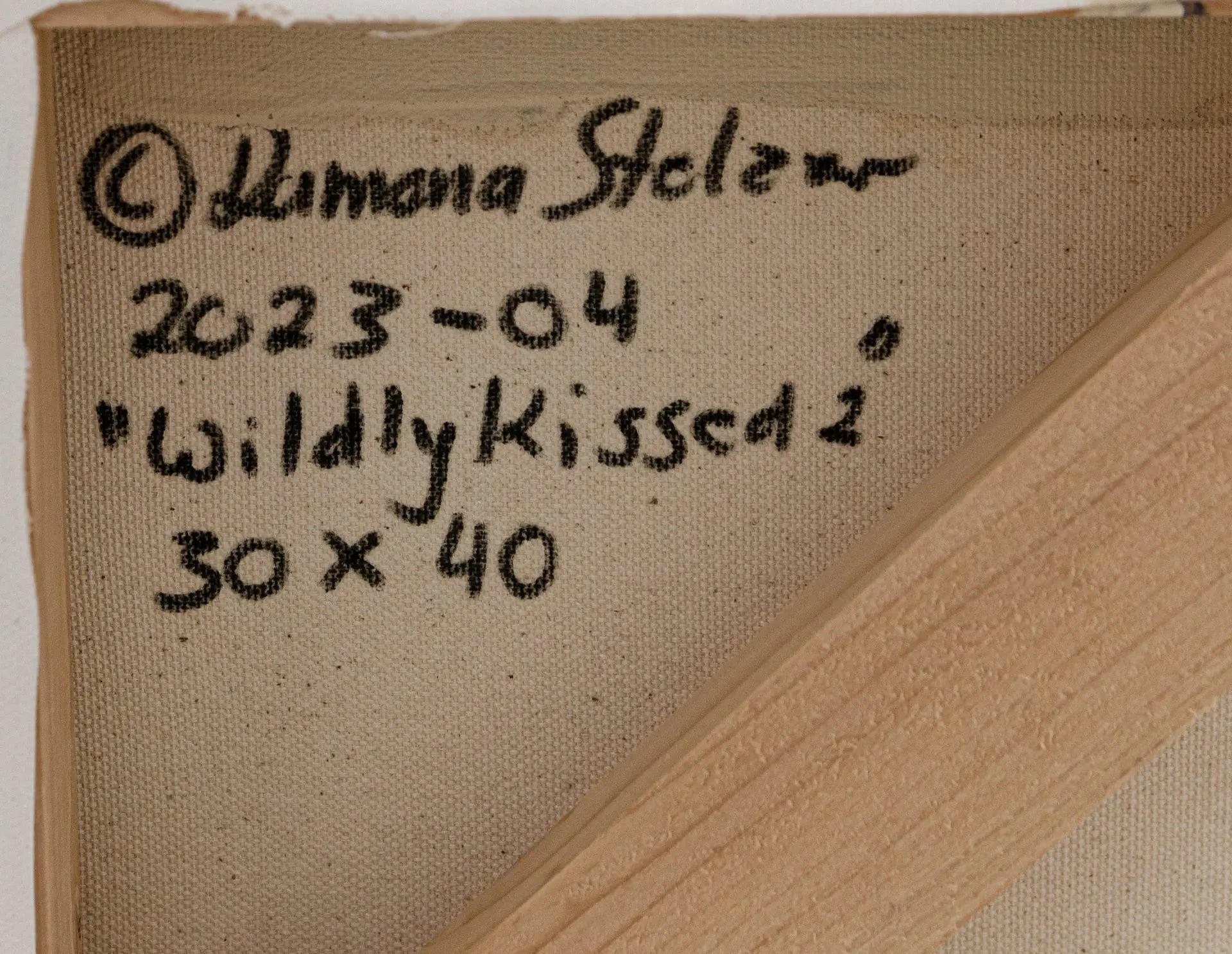 A detailed close up photo of the artist's signature and copyright on the back of a large floral painting Wildly Kissed #2 by Ramona Stelzer