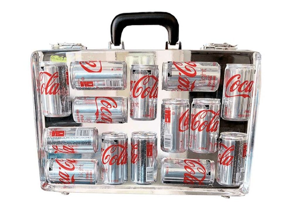 DIET COKE by Emmanuel Meneses - Handcrafted briefcase consisting on 14 Coca-Cola Light mini cans full
casted in transparent resin, sanded and polished by hand.